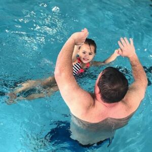 A man and child in the water.