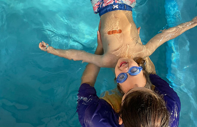 A person in the water with goggles on.